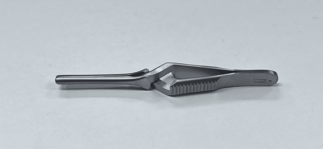 A DEBAKEY BULLDOG CLAMP on a white surface.