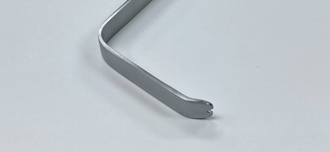 A SOFIELD RETRACTOR handle on a white surface.