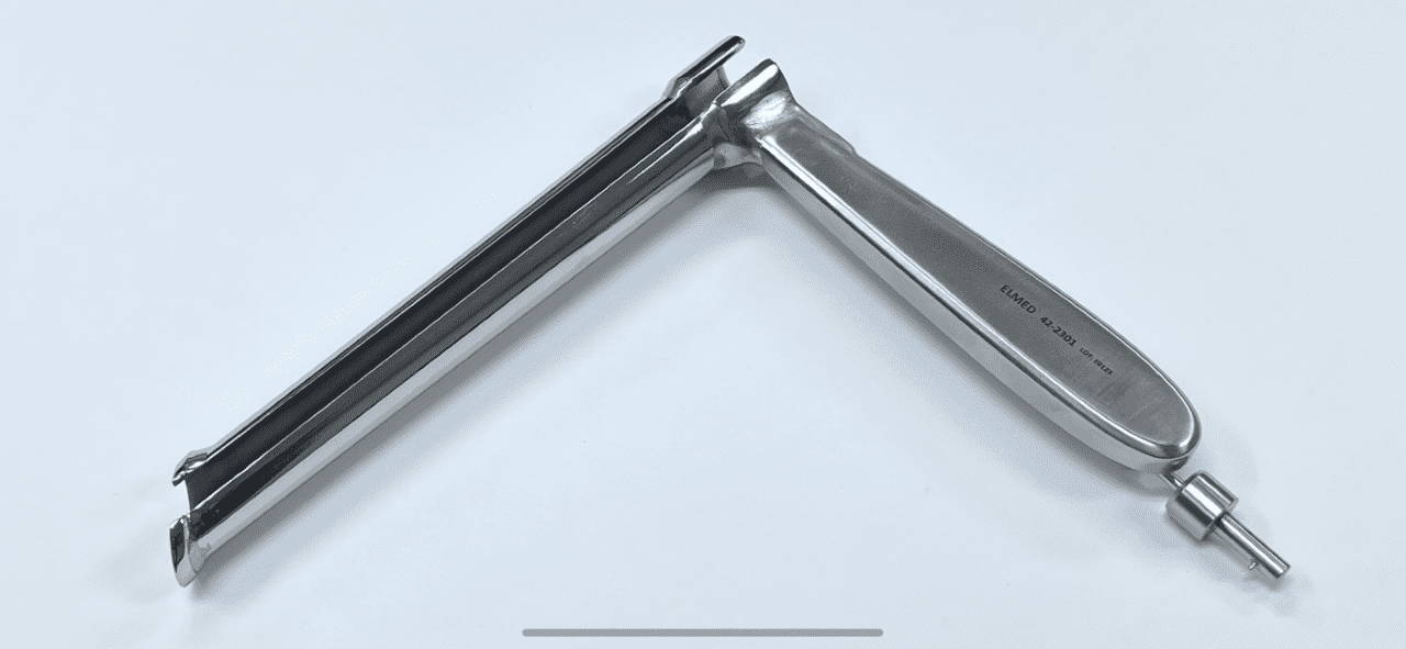 A Carlen Type Mediastinoscope on a white surface.