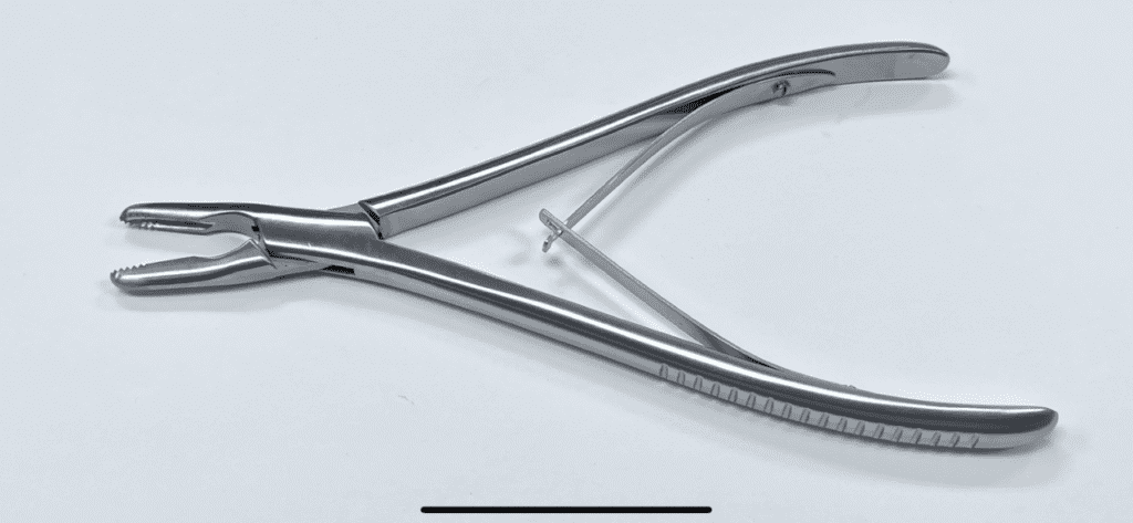 A pair of HANNUM TYPE GRASPER pliers on a white surface.