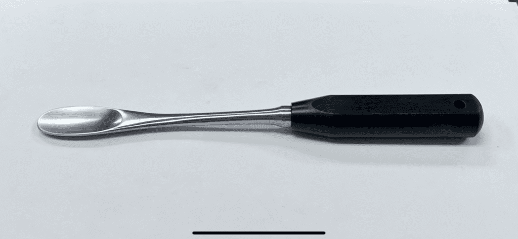A FEMORAL HEAD DISLOCATION LEVER, MUELLER TYPE with a black handle on a white surface.