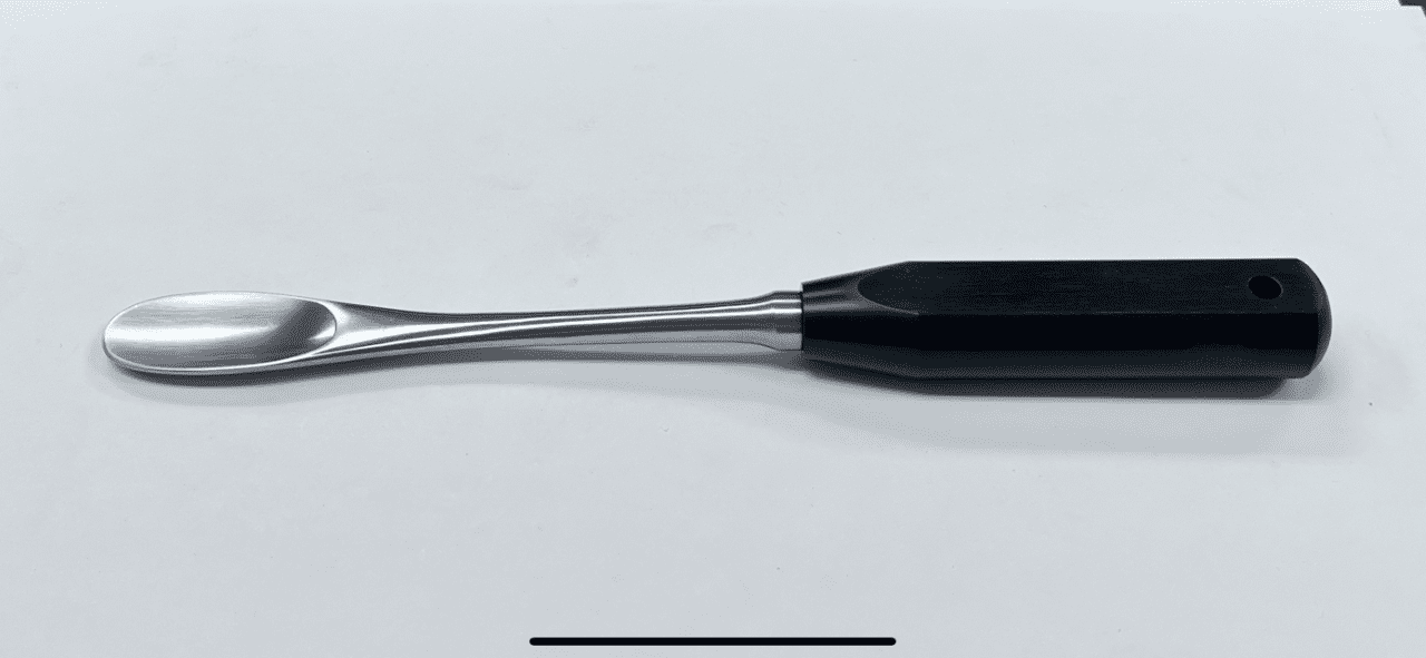 A FEMORAL HEAD DISLOCATION LEVER, MUELLER TYPE with a black handle on a white surface.