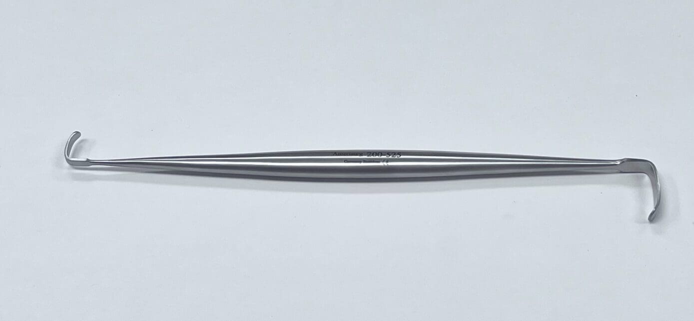 A RAGNELL RETRACTOR with a handle on a white surface.