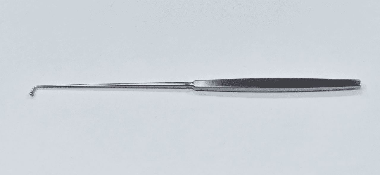 A MCCULLOUGH BALL PROBE with a long handle on a white surface.