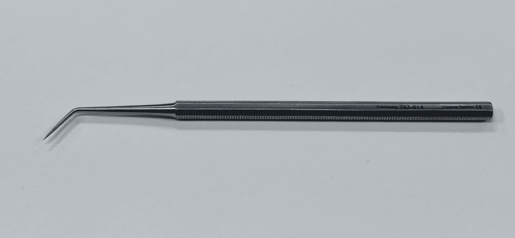 A BUNNELL DISSECTING PROBE with a long handle on a white surface.