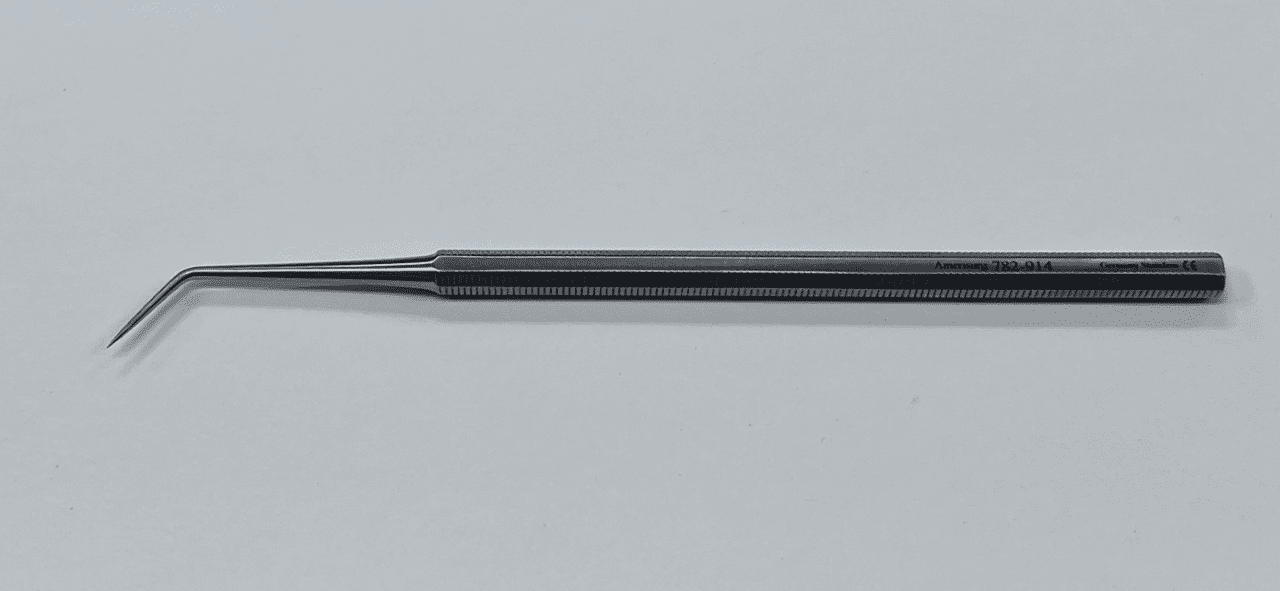 A BUNNELL DISSECTING PROBE with a long handle on a white surface.