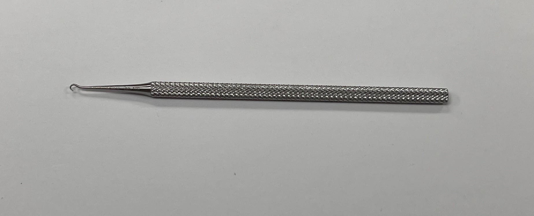 Kilner Skin Hook Placed on a White Background