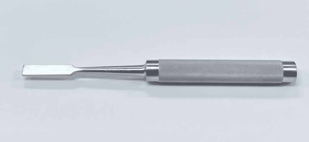 A MOE IMPACTOR with a metal handle on a white surface.
