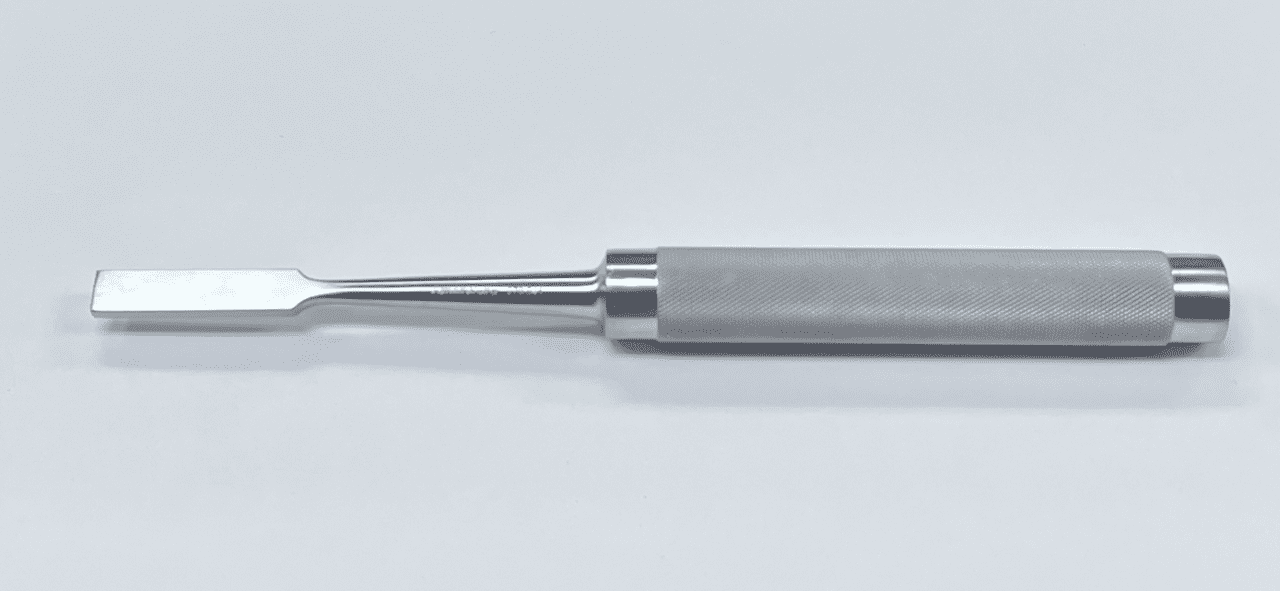 A MOE IMPACTOR with a metal handle on a white surface.