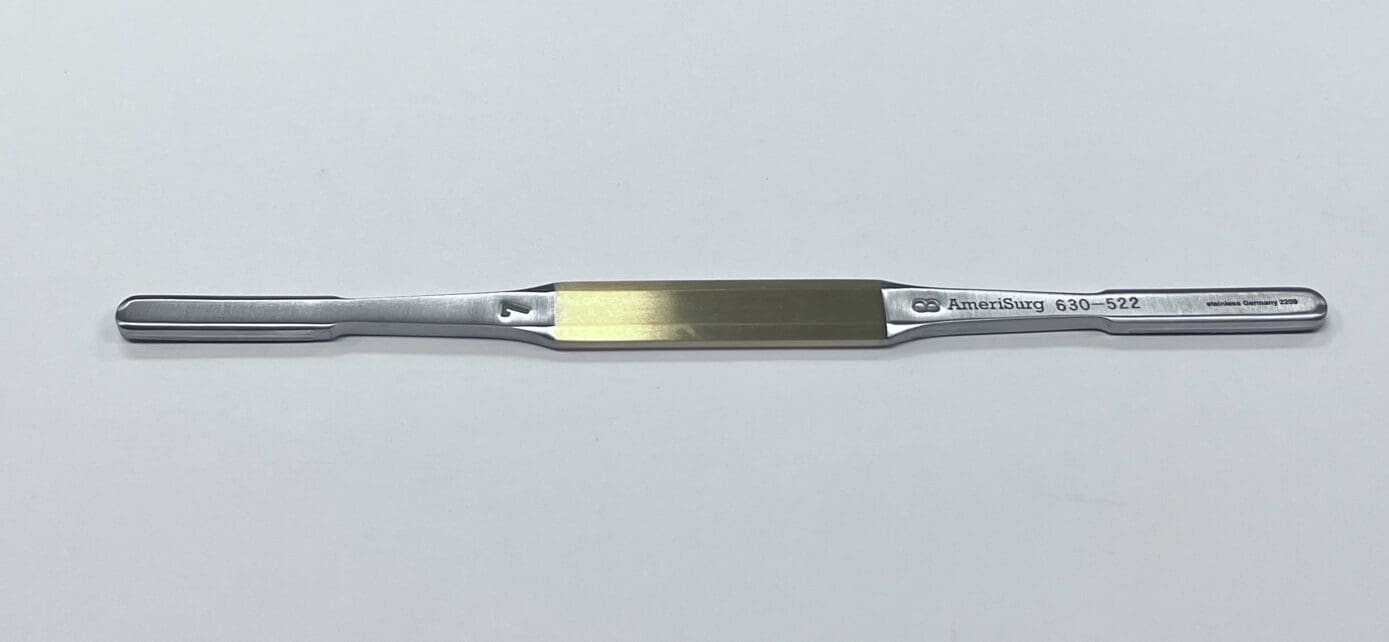 A TC RASP with a gold handle.