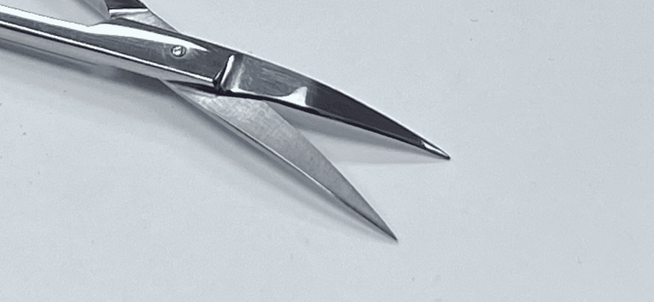 A RAZOR IRIS SCISSOR on a white surface.