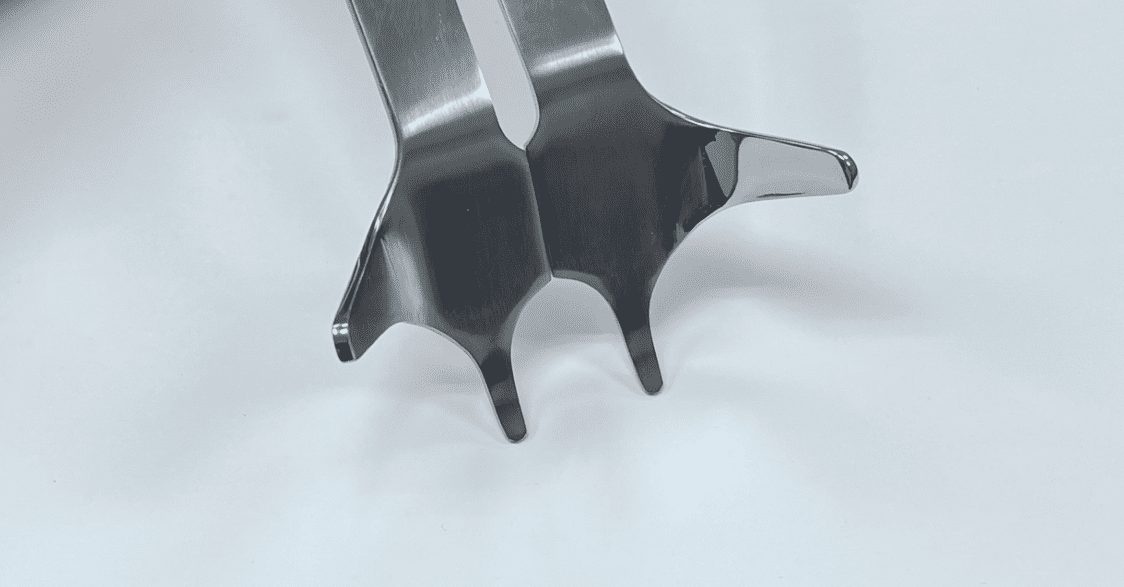 A pair of POSTERIOR-INFERIOR RETRACTORs on a white surface.