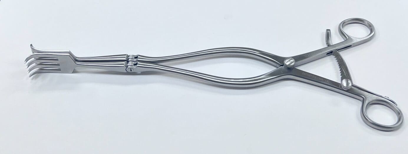 A metal pliers on a white surface.