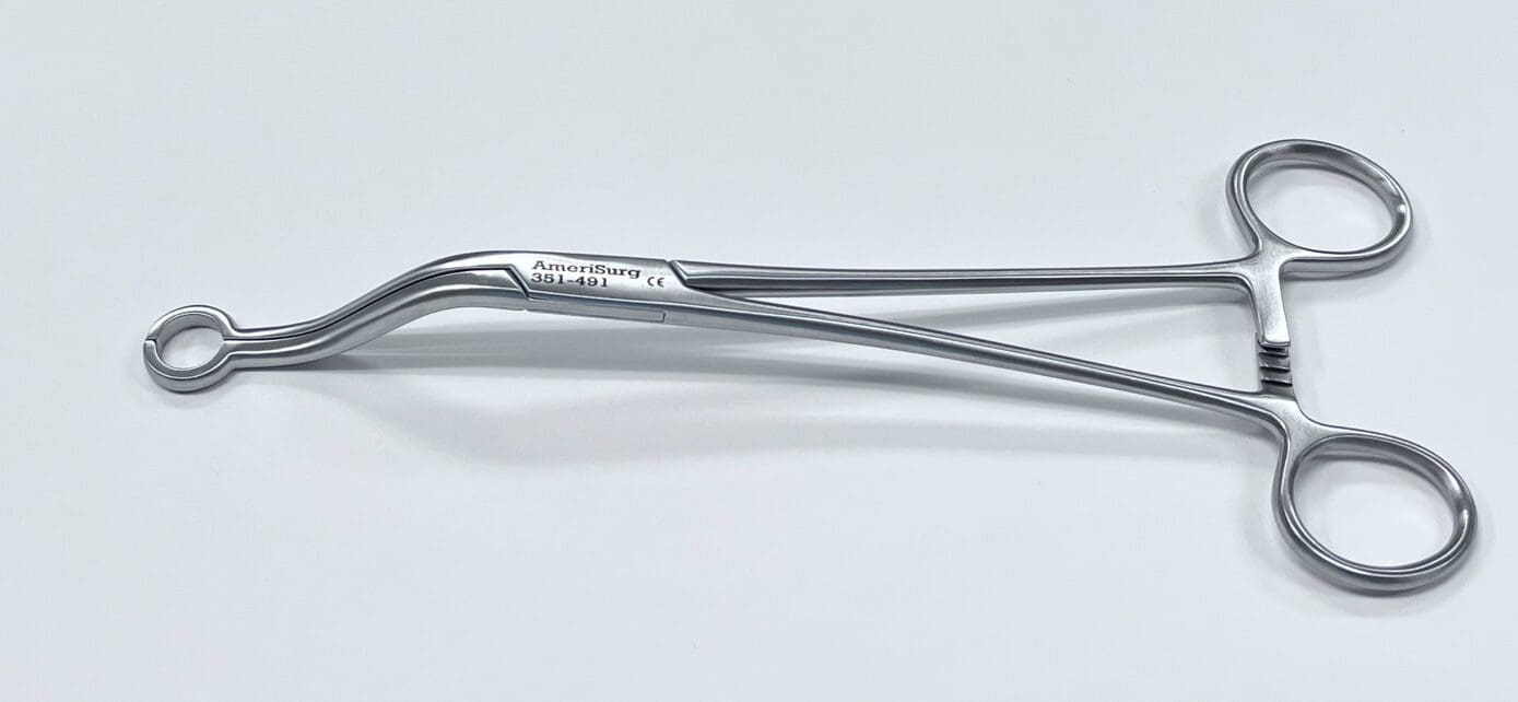 A FEMORAL COMPONENT TRUNNION CLAMP on a white surface.