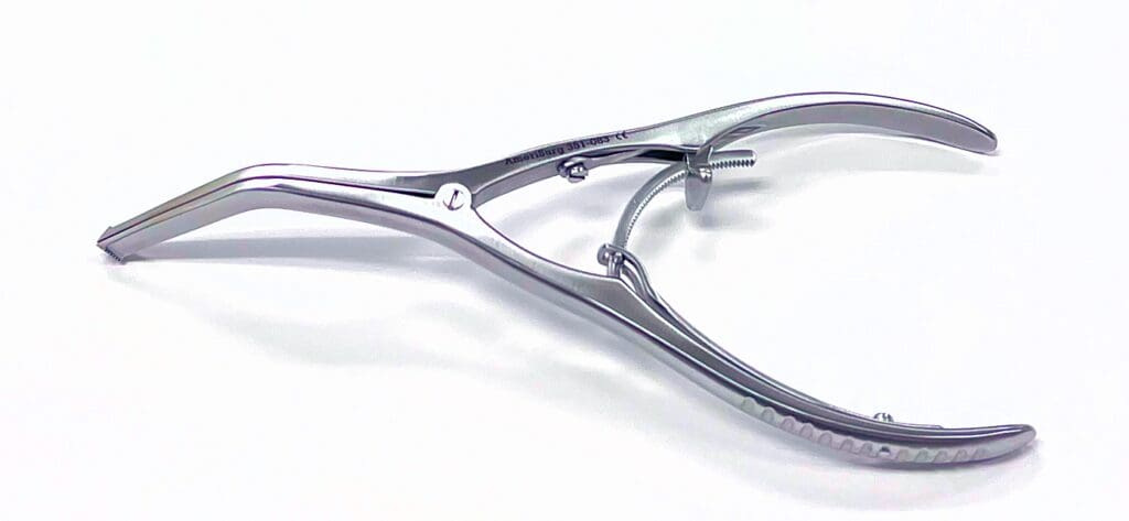 A silver metal bone spreader with a screw on the end.