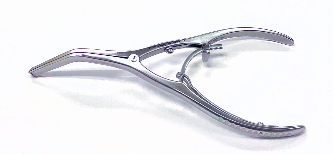 A silver metal bone spreader with a screw on the end.