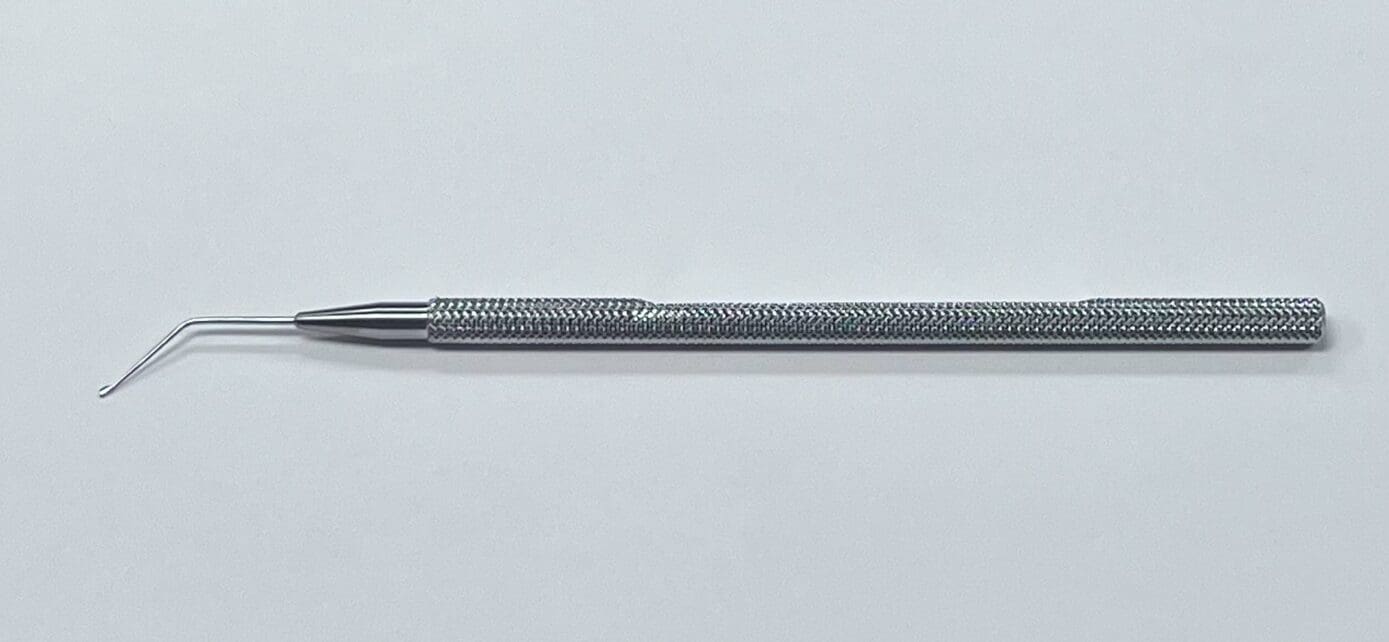 A DRYSDALE NUCLEUS MANIPULATOR is sitting on a white surface.
