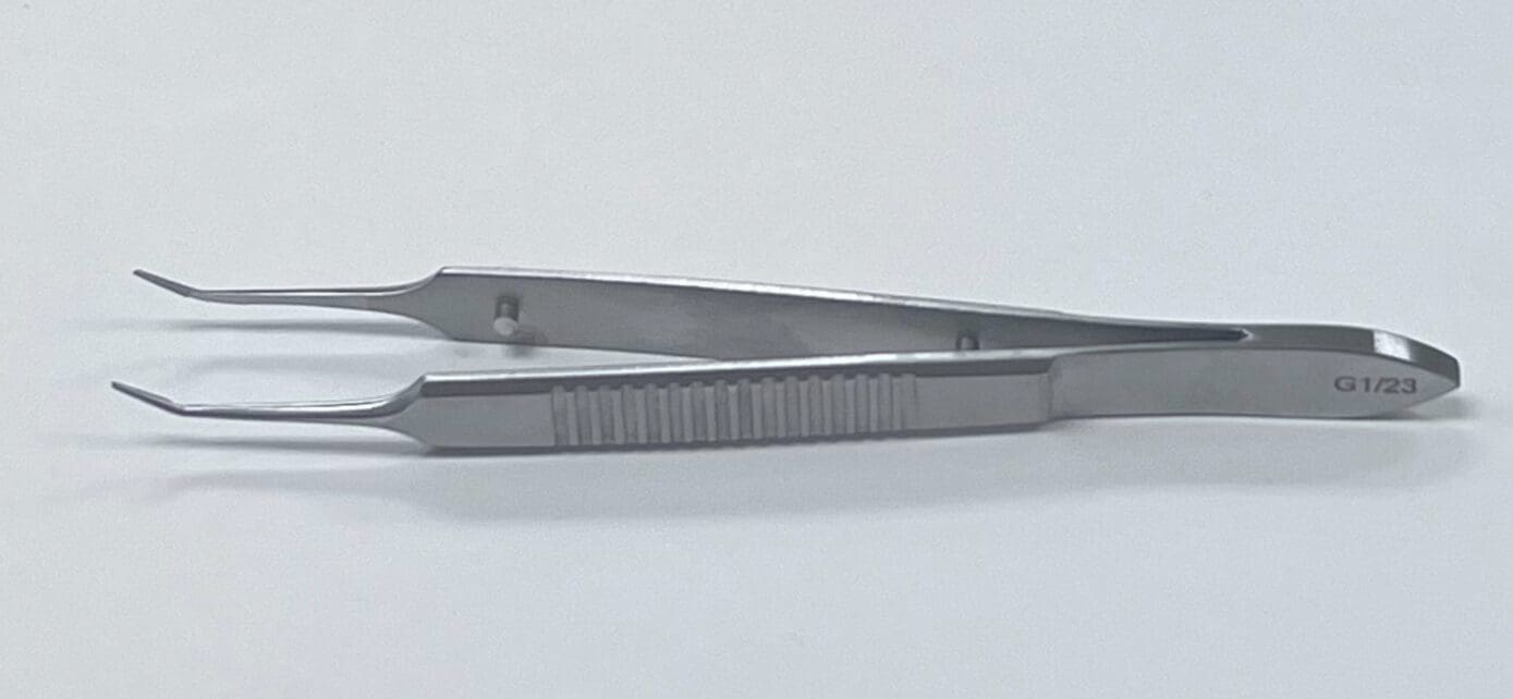 A MCPHERSON TYING FORCEP on a white surface.