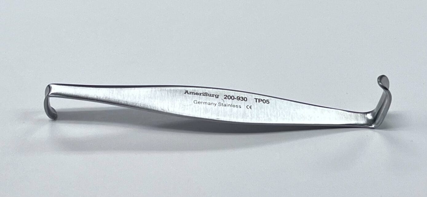 A CRILE RETRACTOR, a stainless steel tool with a name on it.